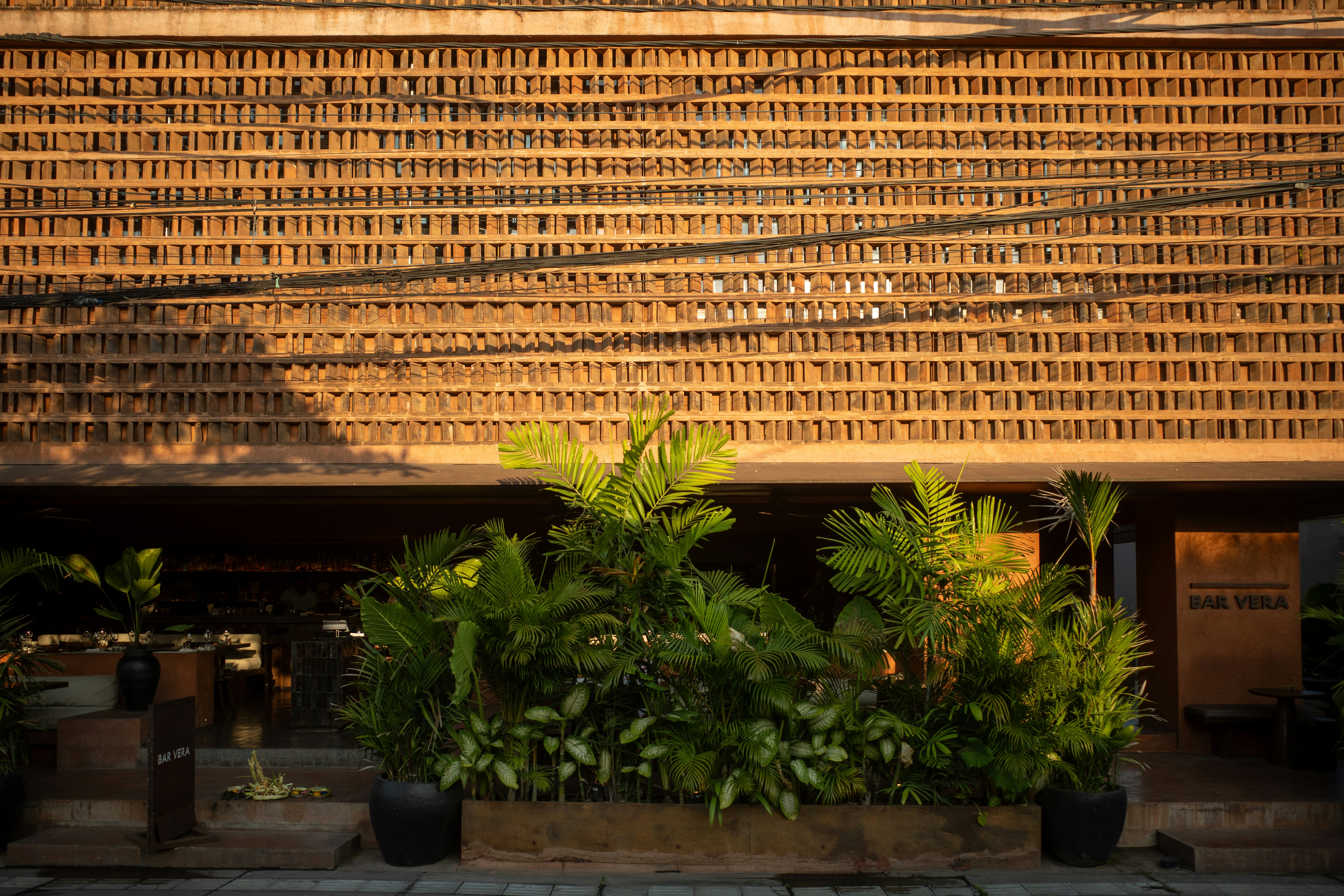 Perforated terracotta facade cladding panels warm earth tones architectural